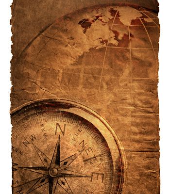 Compass and globe on a richly textured surface